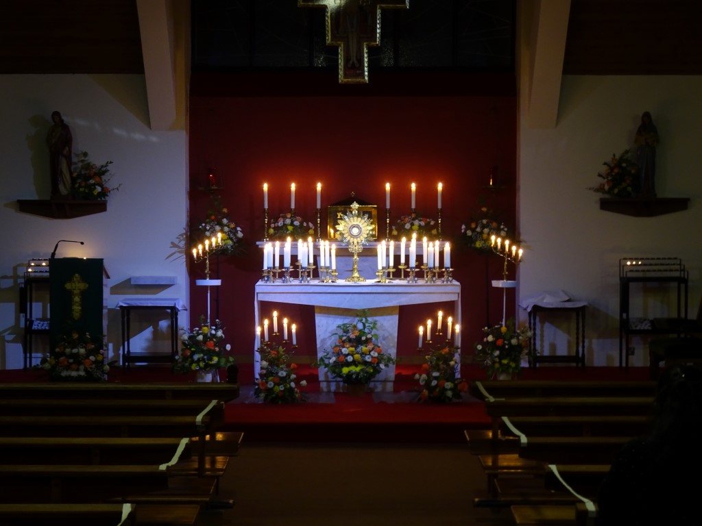 Candlelit altar at St Clare's during Adoration